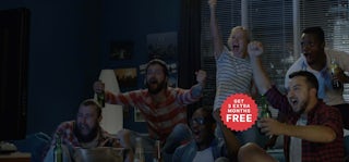 Group of people watching sport together and cheering. Hero super desktop with 12+3 badge.
