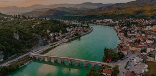 Aerial shot of river through town in Bosnia and Herzegovina