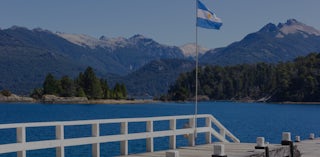 Argentina lake and flag on jetty