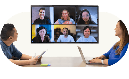 meeting room with employees on zoom call
