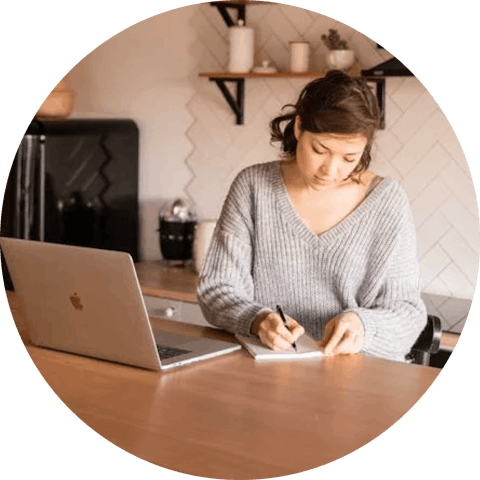 Work from home woman with laptop and notepad.